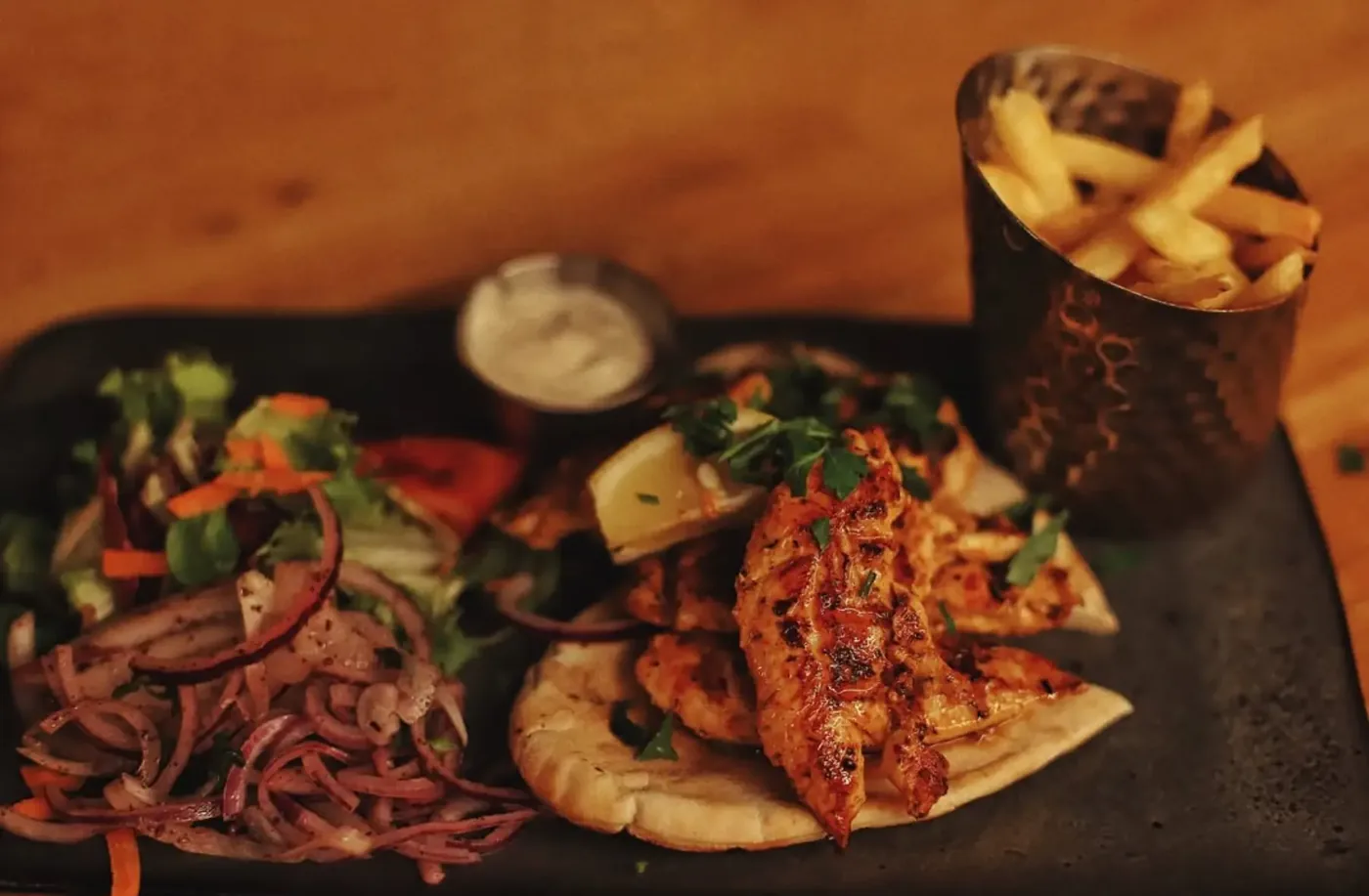Grilled chicken with flatbread, salad and fries