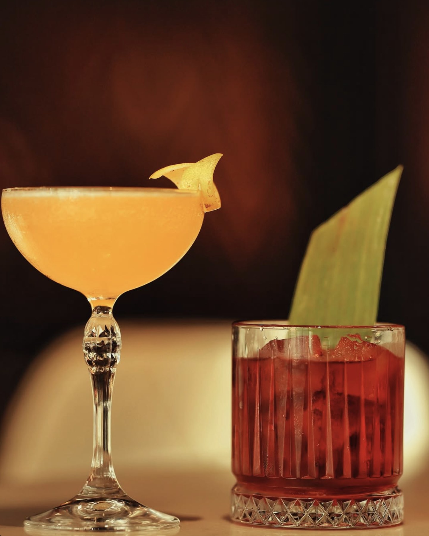 Coupe and negroni on the bar