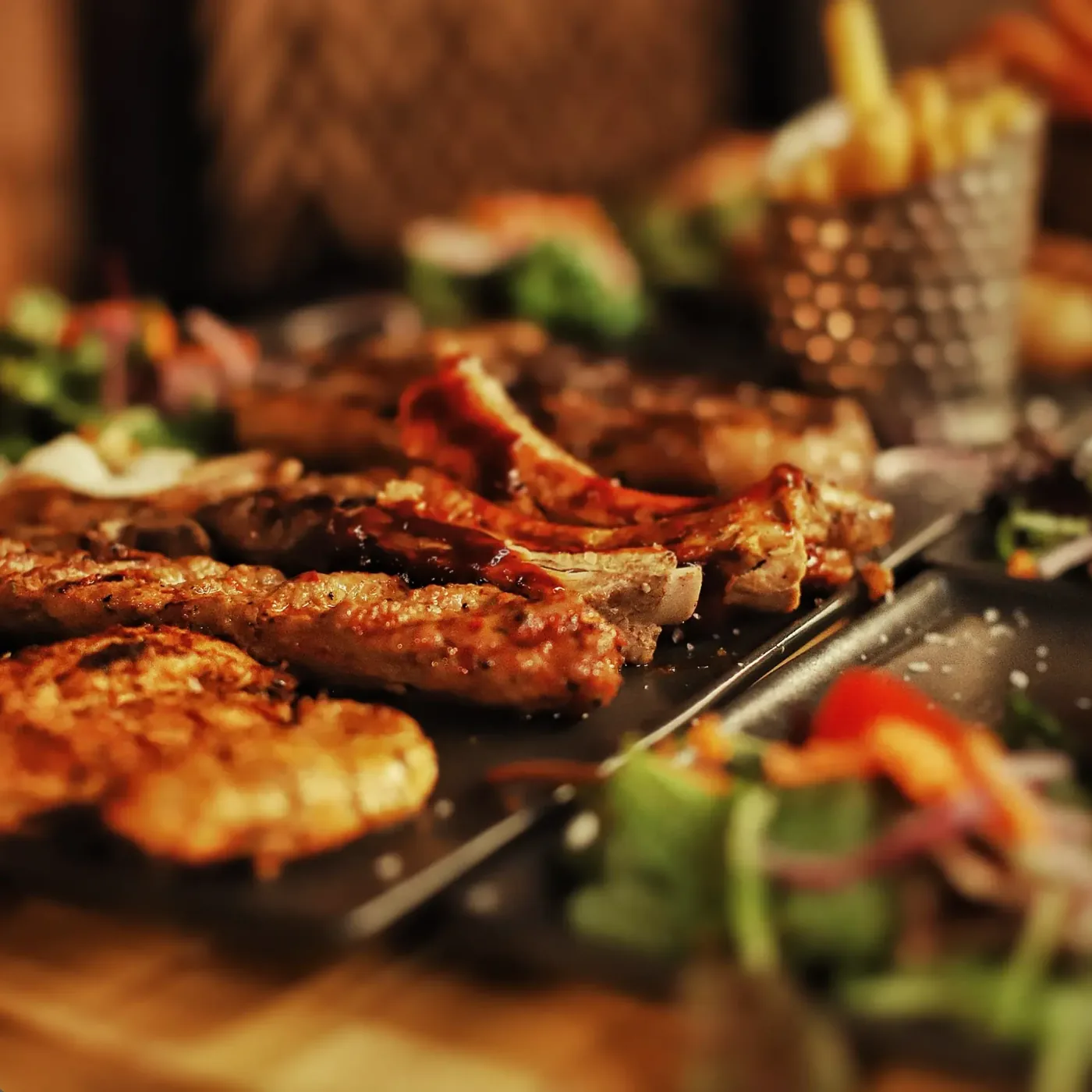 Sharing board of ribs, grilled chicken and skewers