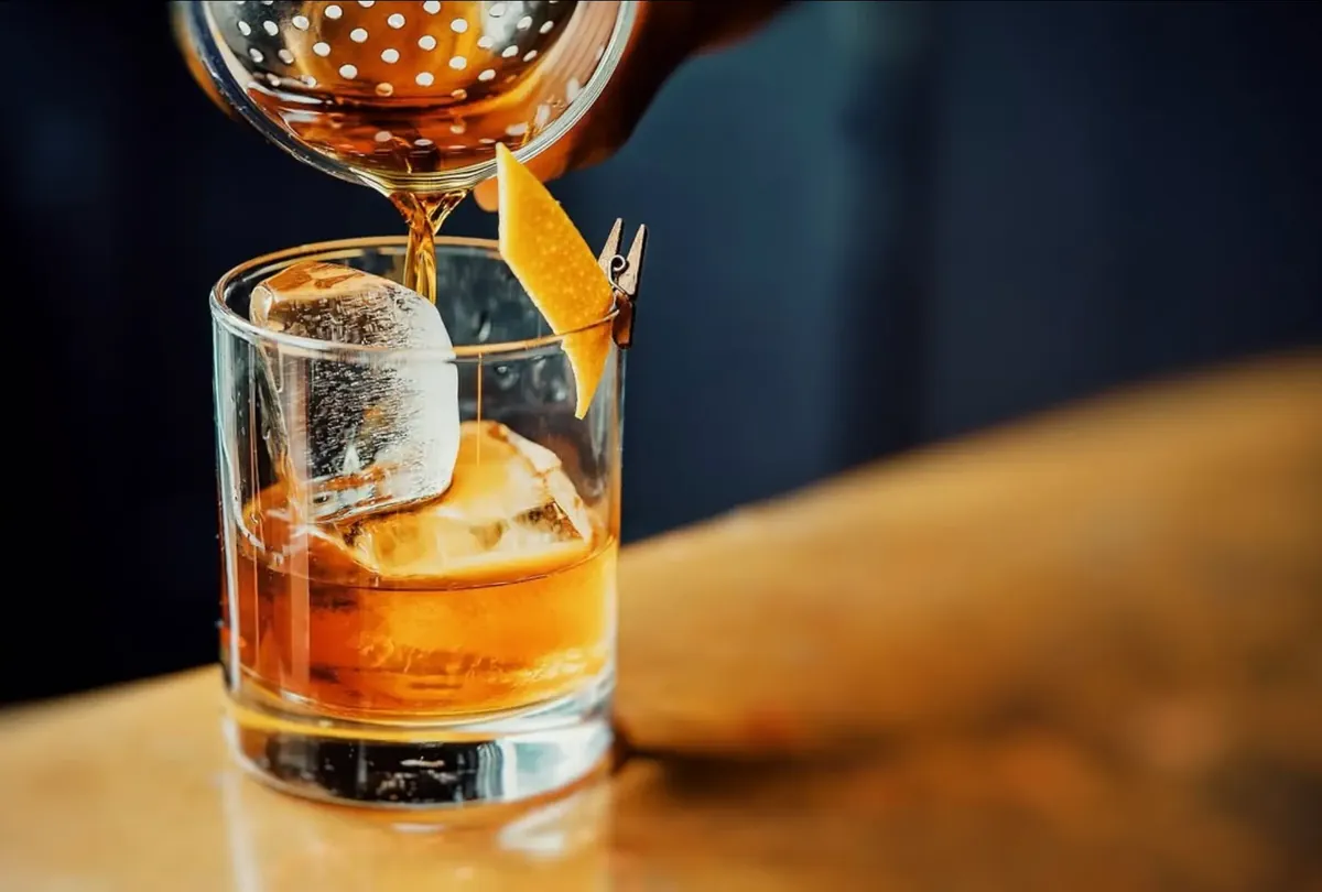 Cocktail strained over ice into a rocks glass
