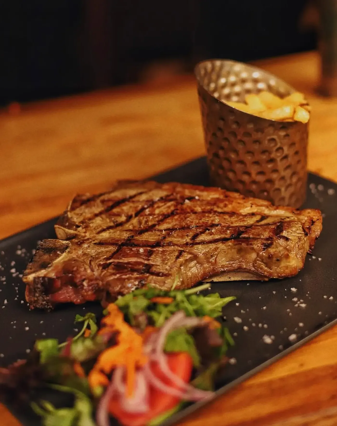 Grilled steak with sea salt, salad and fries
